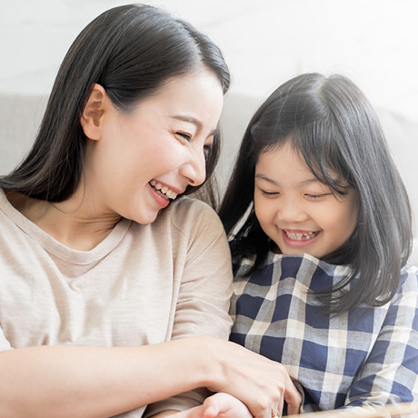 A woman and girl are have a fun conversation.