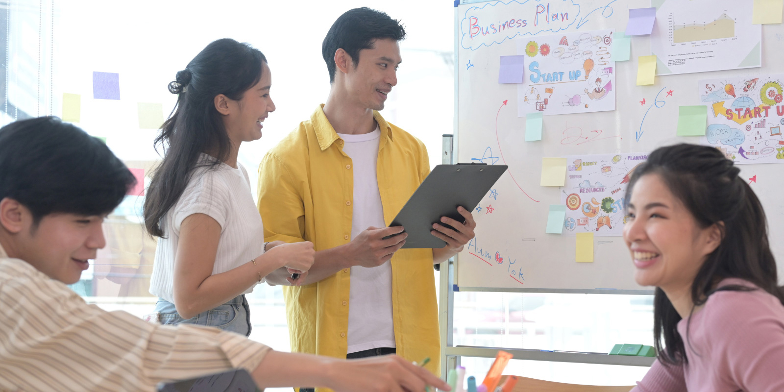 Group of people discussing business plan.