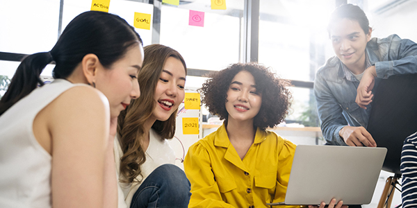 Group of people discussing goal over laptop.