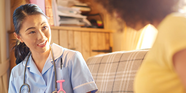 A female nurse is consulting a pregnant woman.
