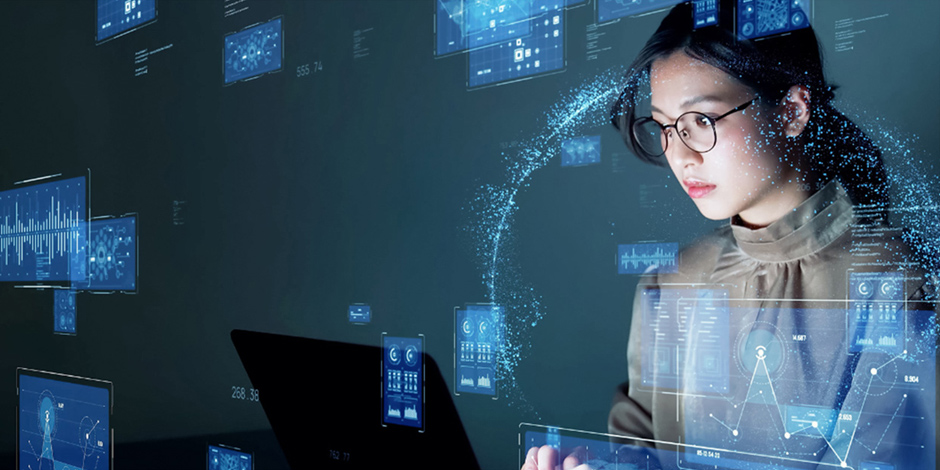 Woman working with laptop with floating digital graphical dashboard on the background.